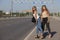 Two beautiful young women are hitchhiking on the road and try to find someone to take them to their hotel