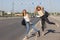 Two beautiful young women are hitchhiking on the road and try to find someone to take them to their hotel