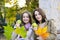 Two beautiful young women holding green apples and smiling