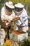Two beekeepers looking at a honeycomb extracted from a hive