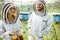 Two beekeepers working on the apiary