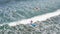 Two Beginners Surfing In Ocean Surf School. People surfing in the ocean of a beautiful beach Bali, Indonesia. Aerial