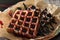 Two Belgian waffles raspberry jam and chocolate