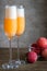 Two bellini cocktails with fresh peaches