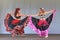 Two belly dancers in long colorful skirts