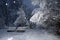 Two benches on the bank of the river under snowfall in a winter park. Snow park. A lot of snow. Scenic beautiful winter landscape