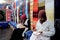 Two Berber women are working in colorful souk fabrics in Morocco