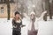 Two best female friends play with snow. Winter outdoor activities, positive emotions, joy and happiness