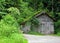 Two bicycles leaning against a wooden cabin