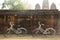 Two bicycles resting against an ancient wall in Sukhothai Heritage Park, Thailand