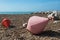 Two big buoys on the beach, azure sea and the rocky beach