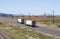 Two big rig semi trucks with reefer semi trailers running on the divided highway in Utah