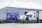 Two big rigs semi trucks with open hoods stand on the parking lot of the repair shop for engine maintenance and inspection and