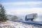 Two big rigs semi trucks with semi trailers go towards each other on the winter wet road with melting snow