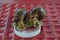 Two big snails (Lissachatina fulica) are drinking water from the lid. Close-up view of animals