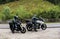Two bikers on mountain roads, stopped to prepare for the rain that will start soon.with the motorcycle on vacation