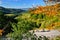 Two bikers ride on the road over autumn landscape