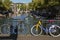 Two bikes in autumn day in Amsterdam with buildings and bridge