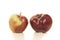 Two biological, organic, red apples with some small faults on a
