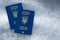 Two biometric international passports of citizen of Ukraine, Ukrainian documents for travel. Gray background, empty place, copy