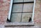 Two Black Birds on a Boarded Window Ledge