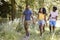 Two black couples walking together in woods