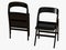 Two black folding chair 3d rendering on a white background