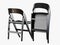 Two black folding chair 3d rendering on a white background