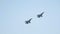 Two black military fighter jets flying up in the sky