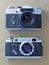 Two black old-school vintage soviet photo cameras FED and Zenit-E on brown. Flat lay, top view