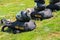 Two Black paratrooper helmets on black parachute knapsacks that say West Point