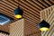 Two black pendant lamps in a wooden interior
