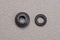 Two of black rubber round spacers for plumbing