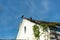 Two black vultures on top of the roof of an old church. Abandoned place