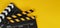 Two Black and yellow Clapper board or movie slate on yellow background