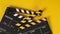Two Black and yellow Clapper board or movie slate on yellow background