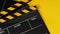 Two Black and yellow Clapper board or movie slate on yellow background