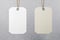 Two blank hanging tags: empty white and eco friendly beige made from recycled kraft paper at grey wall background. Recycle concept