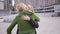 Two blond girlfriends with shopping bags met on the street after shopping. Two fashion women hugging, they glad to see