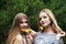 Two blonde girlfriends with dandelions.