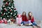 Two blonde girlfriends sisters girls Christmas presents new year tree