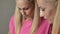 Two blondes,twin sisters,in pink clothes,cook together,communicate,laugh