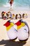 Two blow up penguins on a sandy beach with lots of blow up penguins behind