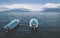 Two blue boats on lake Atitlan with view on volcanoes San Pedro and Toliman in Santa Cruz la Laguna, Guatemala