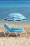 Two blue lounge chairs on a beach in Hanioti, Greece