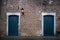 Two blue twin doors in a castle court yard