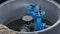 two blue valves for supplying water to the sewer well