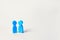 Two blue wooden figures of people stand on white background. two persons of homosexual orientation. the concept of relations betwe