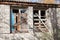 Two boarded windows of an abandoned house