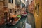 Two boats in a narrow channel in venice